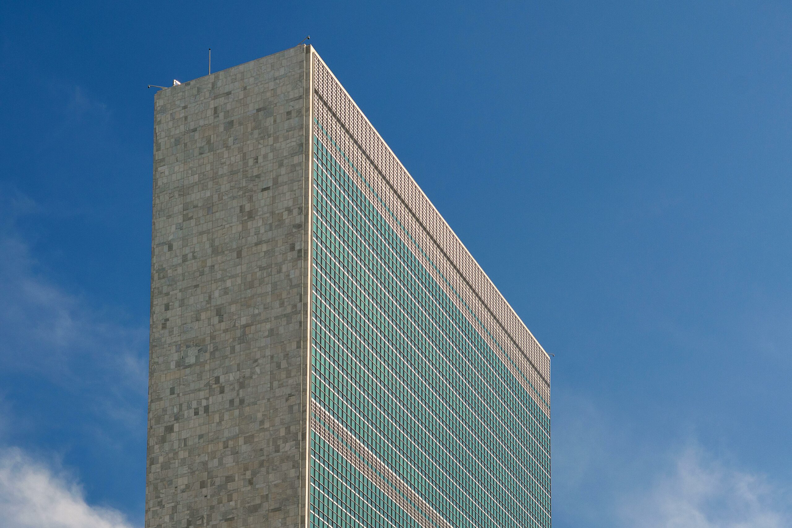 The iconic United Nations building in NYC captured against a vibrant blue sky, showcasing its modern architecture.